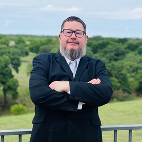Willie Buehler, SEO and Content Marketing Manager, with the Texas Hill Country in the background.